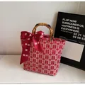 Detail of red wedding tote bag with bamboo handle and silk bow showing Double Happiness motif - Red (Bai Xi)