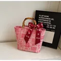 Macro shot of bamboo handles and festive silk ribbon on pink wedding canvas tote bag - Pink (Da Xi)
