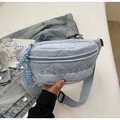 Light blue quilted nylon chest bag with embroidered letters and adjustable strap - Blue
