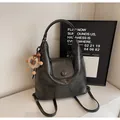 Black vegan leather tote bag with a cute brown bear charm for daily commute and casual use - Black With Rabbit Pendant