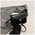Close-up of black glossy leather crossbody bag with metallic silver twist-lock closure - Black without Pendant