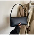 Detailed view of a black baguette shoulder bag in matte PU leather with smooth lines - Black