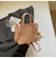 Light pink tote bag with embossed cartoon patterns and a cute plush monster charm - With Ornament / Pink