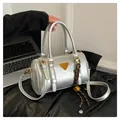 Silver metallic bowling bag with golden logo plate and woven rope bell pendant - Silver