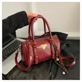 Retro deep red bowling bag in glossy leather with gold hardware and top handles - Red