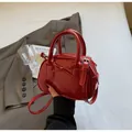Detail of red patent leather handbag with bow design and adjustable strap - Burgundy