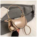 Detail of beige crescent underarm bag on a wool coat with chain and plush charm - Khaki