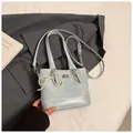 Detail shot of light blue quilted handbag with pearl bow and silver twist lock closure - With Ornament / Blue