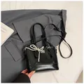 Detail of black quilted leather handbag with pearl bow charm and silver twist lock - With Ornament / Black