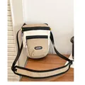 Detail showing the Lucky label and purple zipper pulls on this color-block crossbody bag - Brown