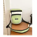 Close-up of three-color patchwork crossbody bag with Lucky patch and zipper details - Green