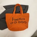 Minimalistische feloranje canvas draagtas met artistieke donkerbruine tekst - Oranje