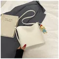 Minimalist white bucket shoulder bag with lychee texture and cute doll pendant - With Ornament / White