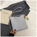 Minimalist light blue bucket bag in smooth PU leather with a cute cartoon pendant - With Ornament / Blue