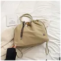 Minimalist khaki nylon drawstring bucket bag with floral metal logo and braided straps - With Baseball Pendant / Khaki