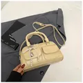 Beige Boston bag with twin front pockets and a pearl bow charm, elegant city style - With Pendant / Yellow