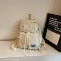 Beige minimalist laptop backpack for students with flap closure and adjustable side buckles - Off White