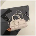 Chic beige Boston bag in vegan leather featuring dual pockets and pearl heart charm - White