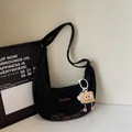 Black crescent dumpling bag with embroidery and plush charm on adjustable strap - Black (With Charm)