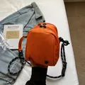 Bright orange mini shell bag in durable nylon with black and white rope strap - Orange