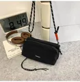 Compact black nylon crossbody bag with Taoleyou logo and rope strap in lifestyle setting - Black