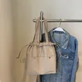 Khaki waterproof nylon tote bag with drawstring closure and front pocket detail - Khaki