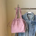 Dusty rose nylon tote bag with drawstring closure and silver rivet pocket detail - Pink