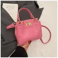 Bright pink textured handbag with woven pattern, golden hardware, and top handle style - Woven Embossing / Pink