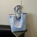 Blue and white checkered canvas tote bag with lace bow and brand logo patch - Blue
