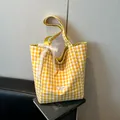 Chic yellow and white checkered canvas tote bag featuring a decorative lace bow detail - Yellow