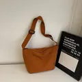 Caramel large canvas tote bag with adjustable black strap and front pocket in minimalist style - Orange