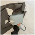 Light blue woven bucket bag with elegant bow charm and thin shoulder strap - Blue