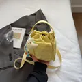 Yellow nylon drawstring bucket bag with S.N.H lettering and moon plush charm - With Ornament / Light Yellow