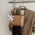 Sac seau en similicuir marron avec poignée tressée et noeud en dentelle violette - Kaki