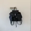 Minimalist black drawstring backpack with flap closure and utility pockets - Black