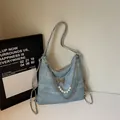 Blue denim texture tote bag featuring silver butterfly charm and pearl chain accent - Sky Blue