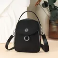 Minimalist black nylon crossbody bag with silver hardware and adjustable wide shoulder strap - Black