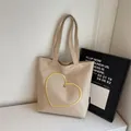 Beige canvas tote bag with yellow heart embroidery and silver metal rivet detail - Off White