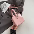 Pink glossy patent leather box bag with adjustable strap and front lettering detail - Pink