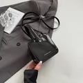 Mini black glossy patent leather box bag with handle and adjustable shoulder strap - Black