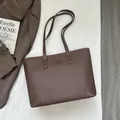Deep brown pebble leather tote bag with elegant shoulder straps for professional commute - Brown