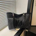 Chic black monogram tote bag set with embossed M logo and matching zipper pouch - Black