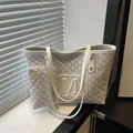 White monogram tote bag set with embossed M logo and matching small coin purse - White