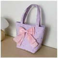 Detail of purple canvas tote bag featuring silver stars and a large pink bow decoration - Purple With Pendant