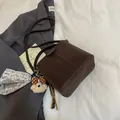 Dark brown suede bucket bag featuring a cute plush bear charm with matching crossbody strap - Coffee (With Pendant)
