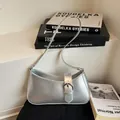 Modern metallic silver hobo shoulder bag with buckle detail in a minimalist aesthetic - Silver
