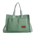Light green canvas tote bag with dual front pockets and adjustable shoulder strap - Green