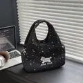 Black star print canvas tote bag with Good Luck dog patch and plaid lining detail - Black