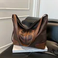 Retro deep brown leather tote bag with large capacity and unique circular cutout design - Brown