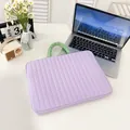 Quilted light purple laptop sleeve with mint green handle on a white desk - Horizontal Purple